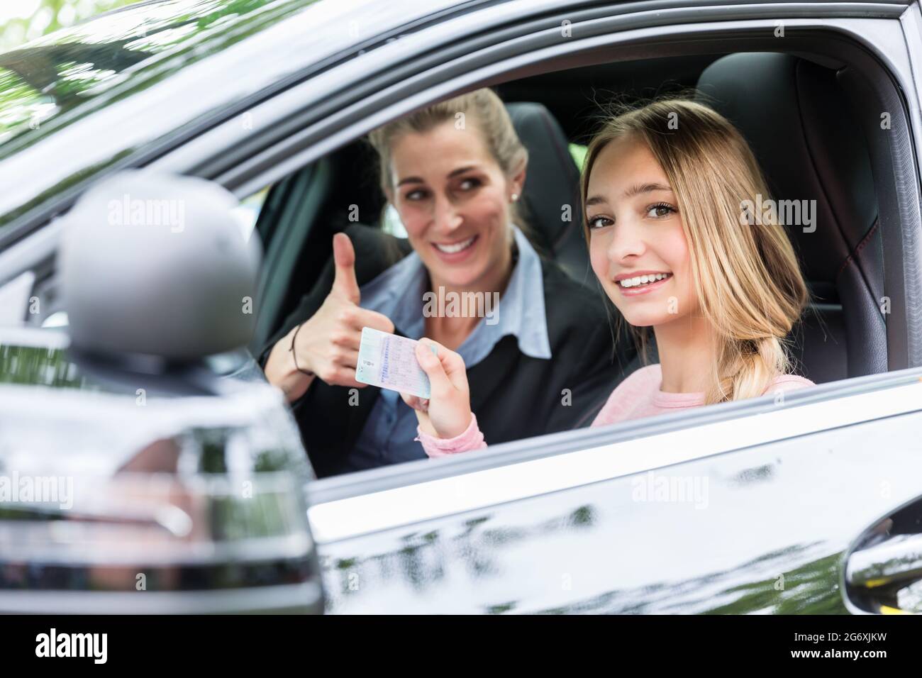 Proud driving student having passed the test showing her license Stock Photo