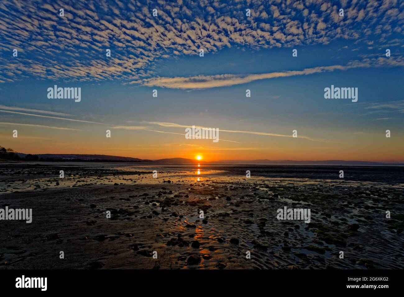 the sun rises marking the beginning of the meteorological summer, Swansea Bay, Wales, UK. Tuesday 01 June 2021 Stock Photo
