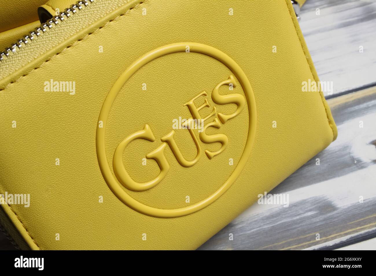 Viersen, Germany - July 1. 2021: Closeup of yellow purse with logo lettering of guess fashion company Stock Photo - Alamy
