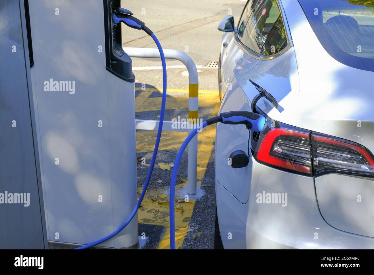 Electric car station closeup. Power supply plugged into an electric