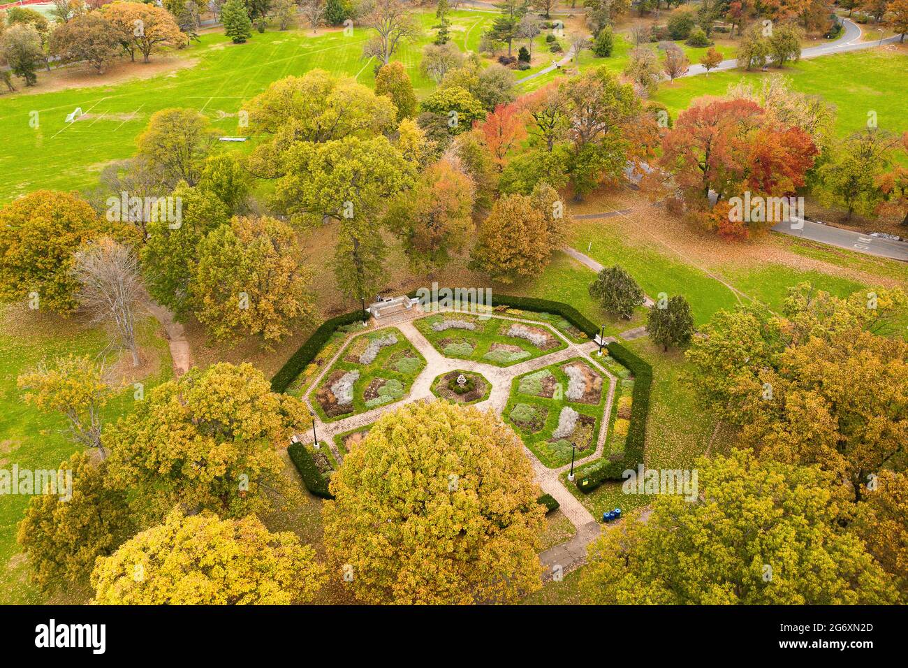 Aerial of a beautiful park in early Fall with a formal garden in the center. Stock Photo
