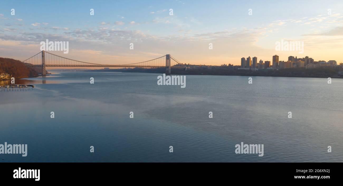 Aerial of the smooth Hudson River from New Jersey with the George Washington Bridge and the NYC skyline in the background. Stock Photo