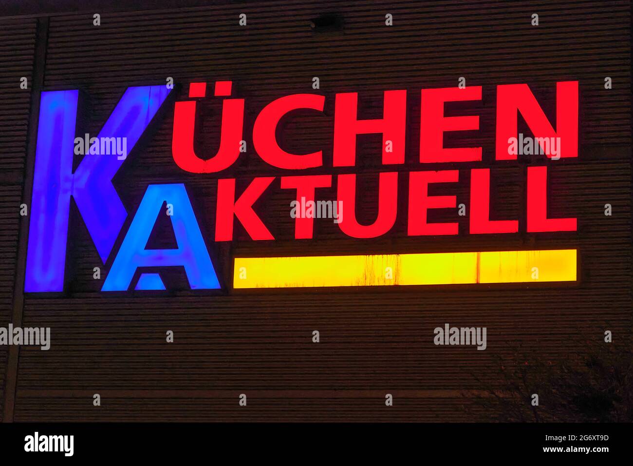Berlin, Germany - December 22, 2020: Facade of a kitchen studio with neon advertising in the evening. Stock Photo