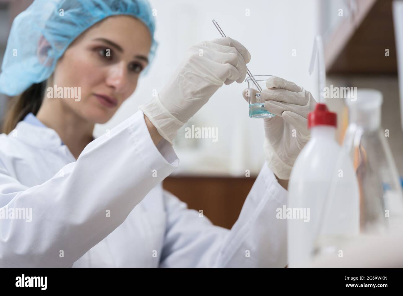 Dedicated female chemist creating an innovative and efficient substance ...