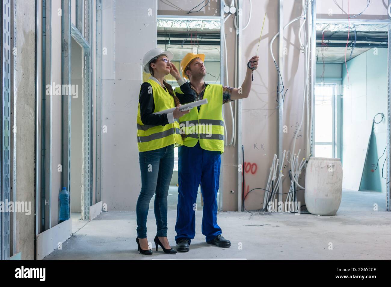 Construction worker and architect discussing work to be done at site to ...