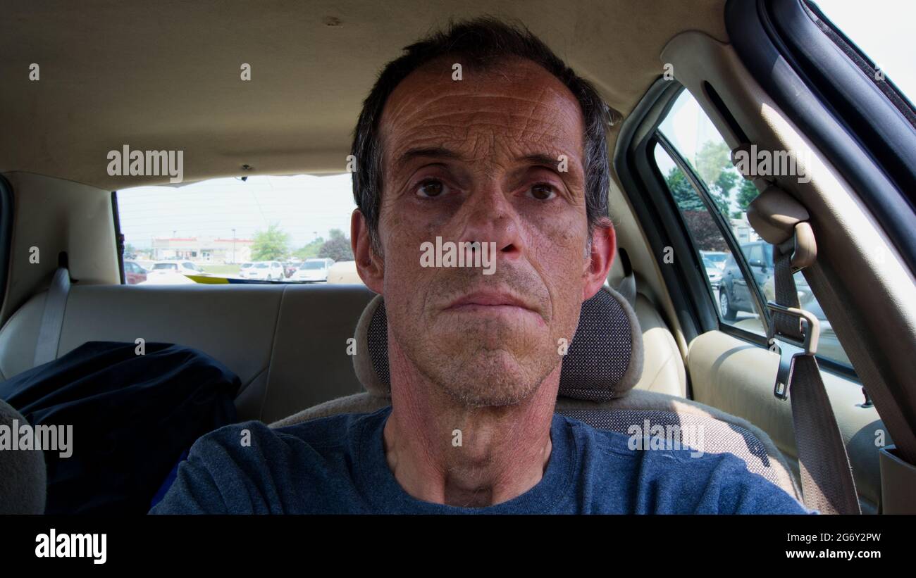 A Middle Aged Male Sitting in a Car Stock Photo
