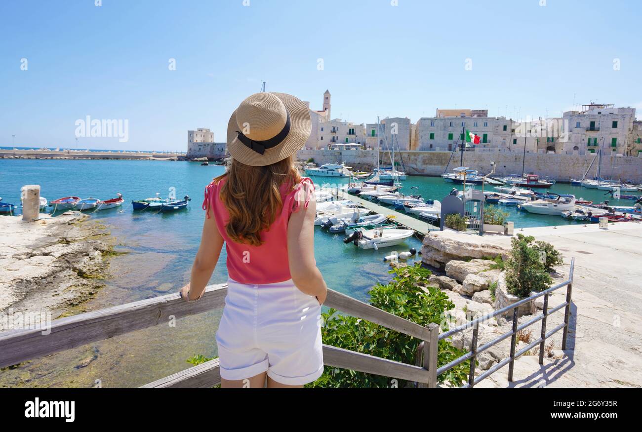 Summer holiday in Italy. Back view of young stylish woman in Giovinazzo old town, Italy. Stock Photo