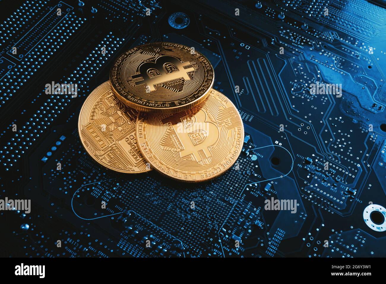 Bit coins on the background of a computer microcircuit Stock Photo