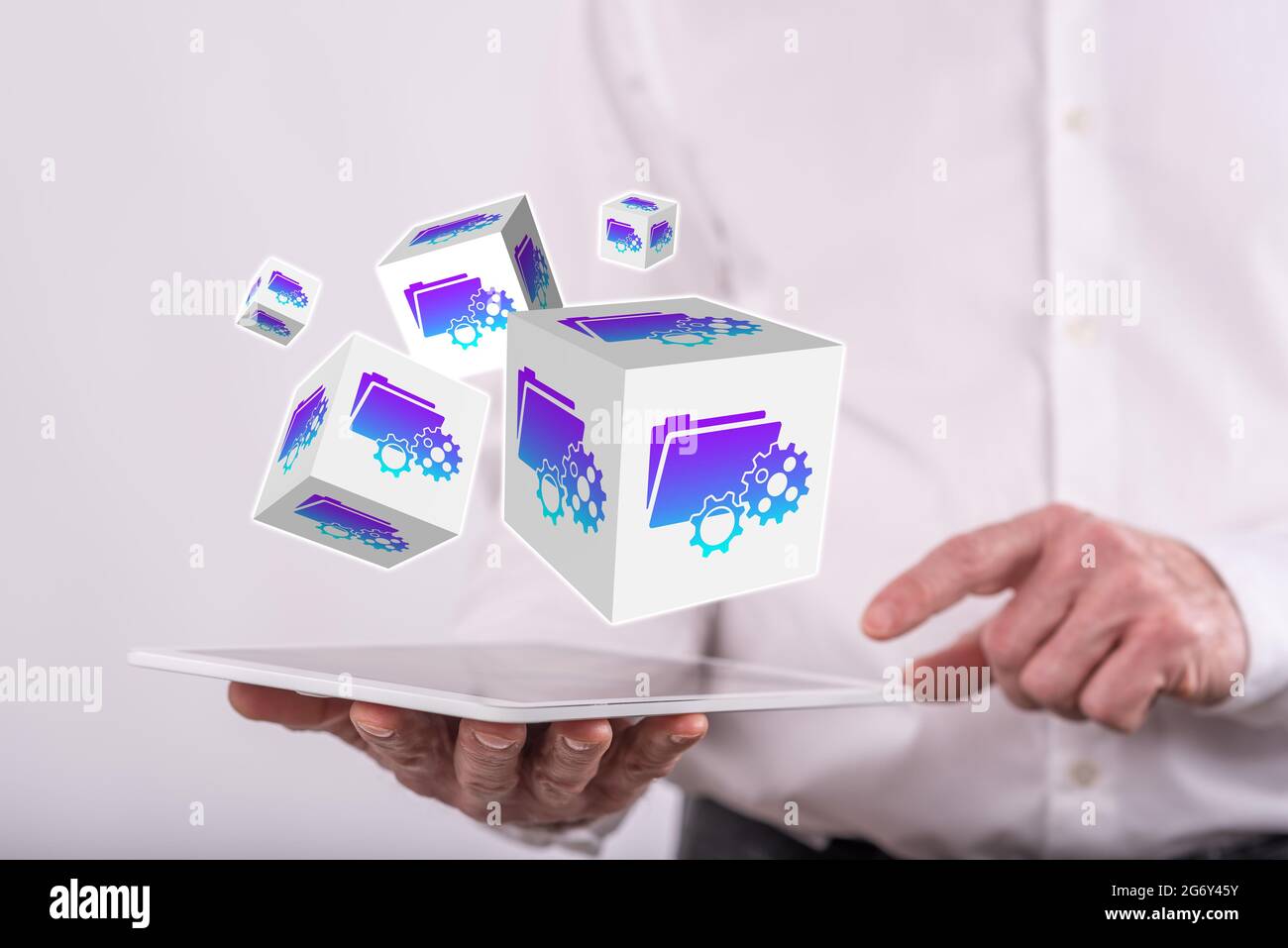 Document management concept above a tablet held by a man in background Stock Photo