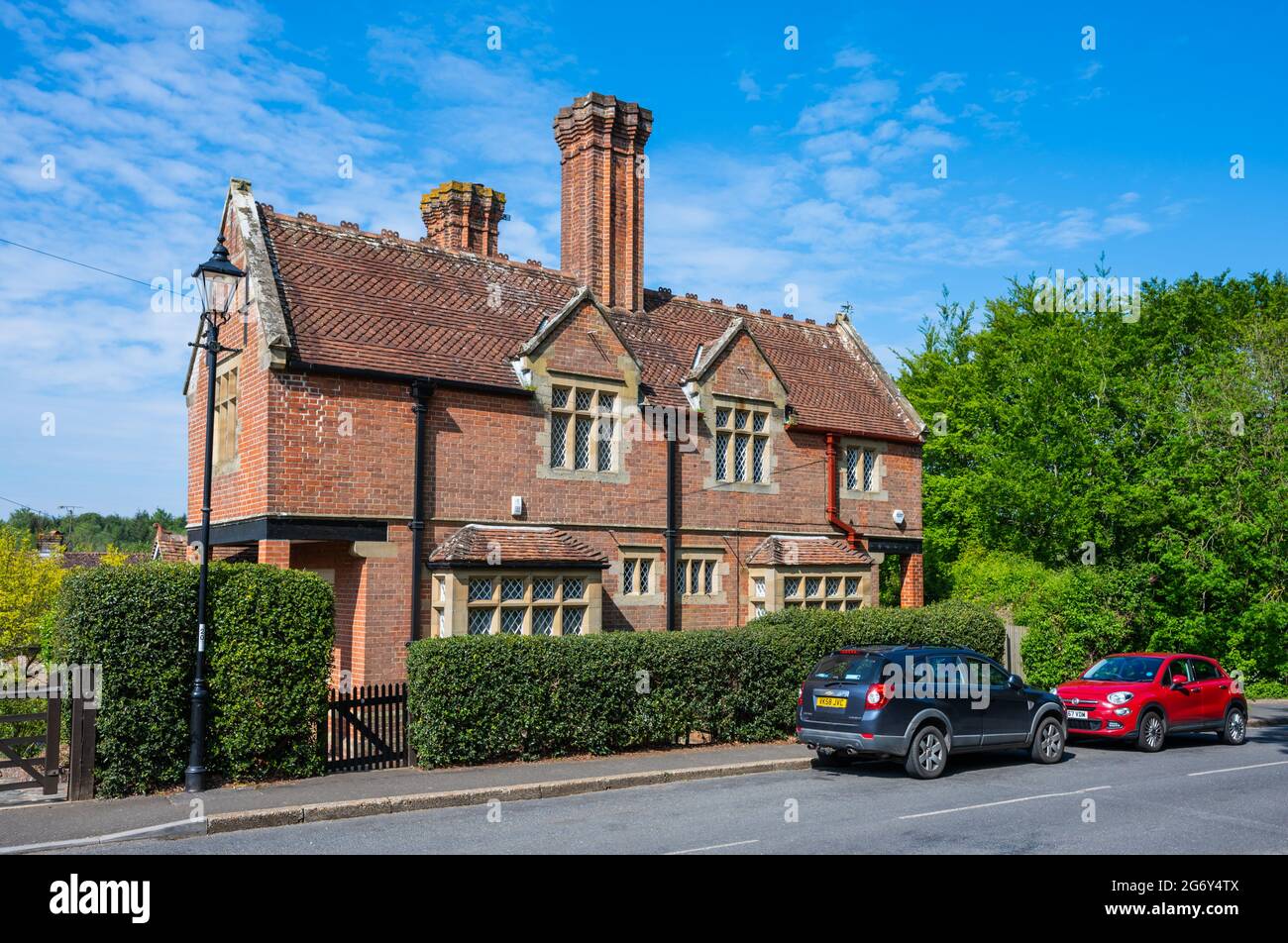 Split level Tudorbethan cottages, built c. 1870. Historic grade II listed buildings with tall shafted brick chimney stacks in Arundel, West Sussex, UK Stock Photo