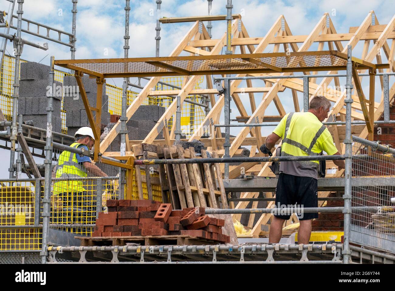 Keepmoat homes property developers, development site in Chorley. Builders Start construction on this large new housing, roofs timber slats dormer, Ridge board, rafters and dormer construction, roof members, cheek fascia board timber boarding soffit framing and cladding apex roof timbers. Pitched roof dormer build on green field estate. Stock Photo