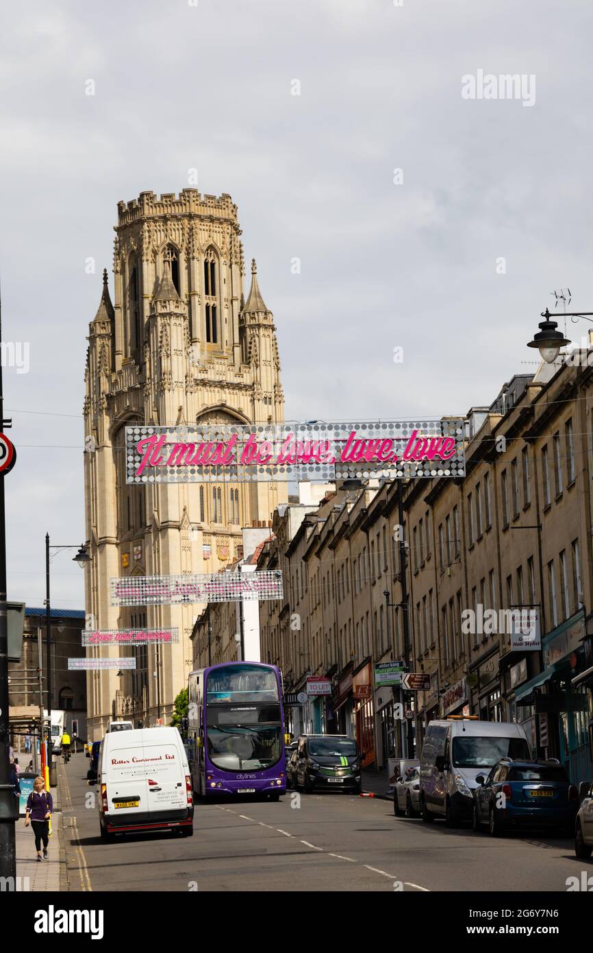 Wills Memorial Tower Building, looking up Park Street with overhanging advert for the Beatles. It must be love, love, love. Bristol city, England Stock Photo