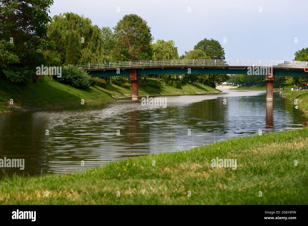 Small Bridge over River with trees and Grass at Summer Stock Photo