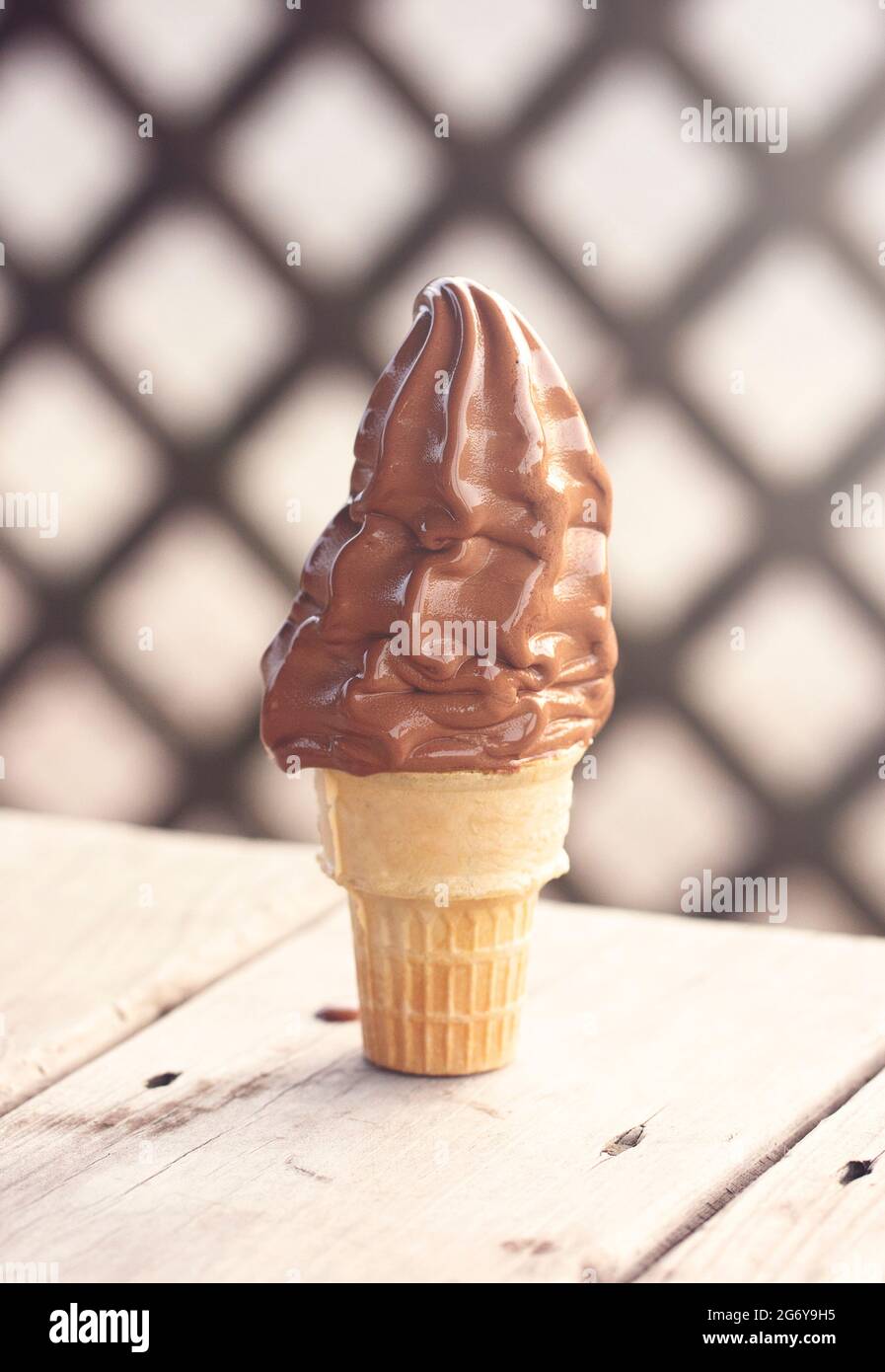 Chocolate Soft Serve Ice Cream Cone Melting in the Summer Heat Stock
