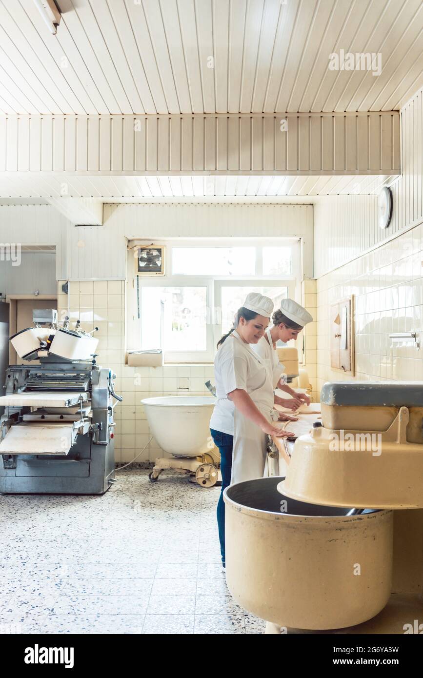 Wide view of bread production in bakery with two women working Stock ...