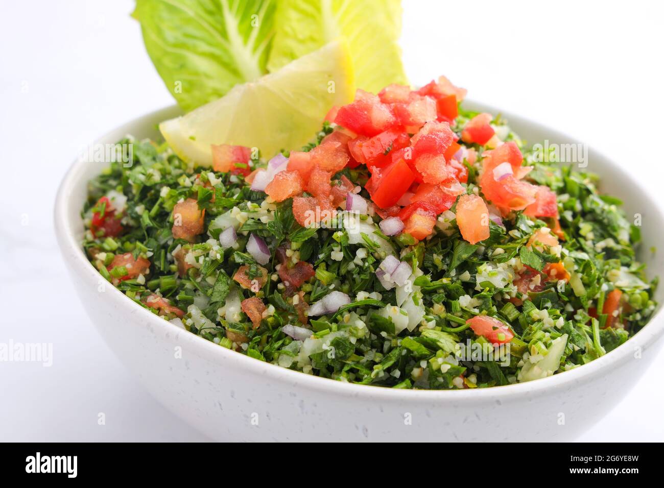 Traditional Arabic Salad Tabbouleh isolated on a marble backdrop Stock