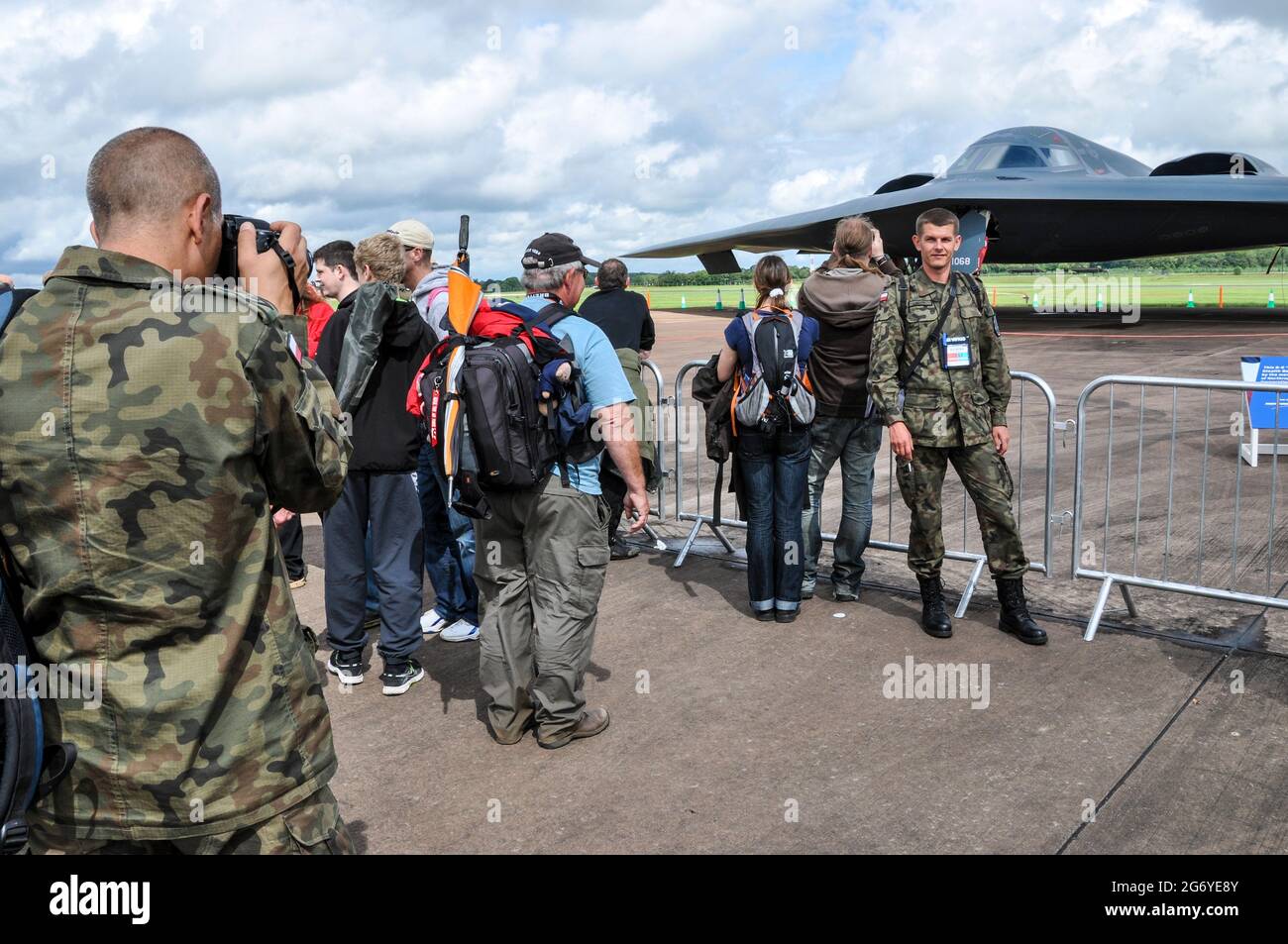 Polish Air Force personnel photographing in front of a Northrop Grumman B-2 Spirit stealth bomber at RIAT airshow. Polish military crew Stock Photo