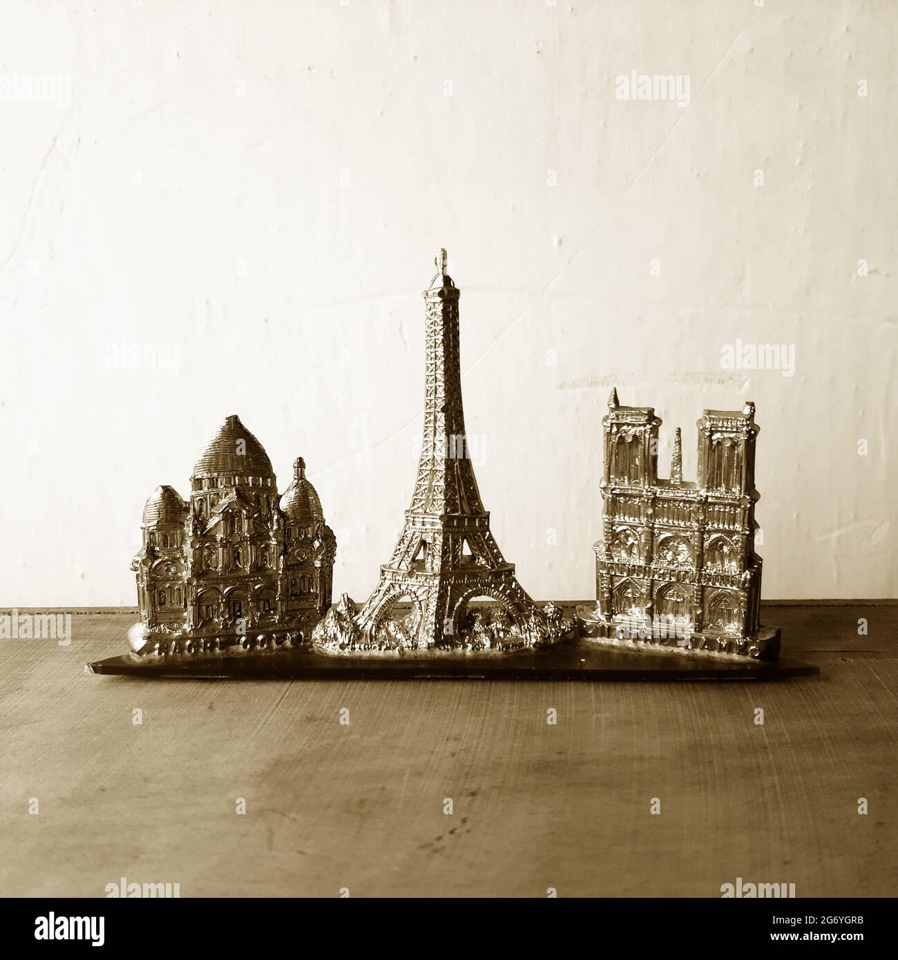 Part from an old plastic Paris Souvenir with the Sacre Coeur, Eiffel Tower and Notre Dame cathedral photographed in sepia tone. Stock Photo