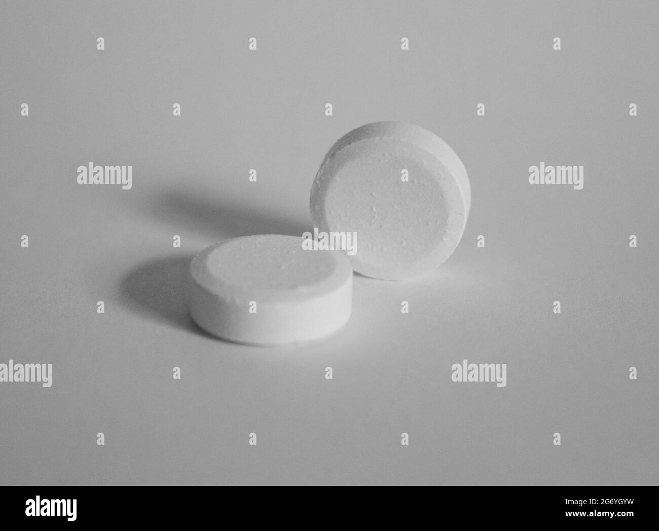 Black and white close-up of two paracetamol tablets Stock Photo