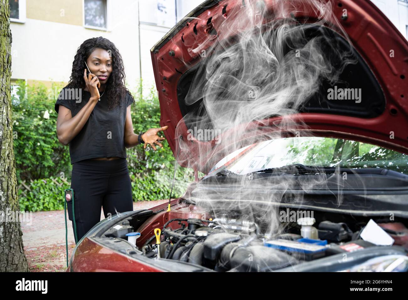 Woman Talking To Reliable Car Mechanic. Breakdown And Crash Stock Photo