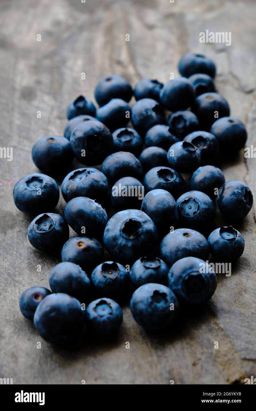 Closeup photograph of delicious blueberries on grey slate background Stock Photo