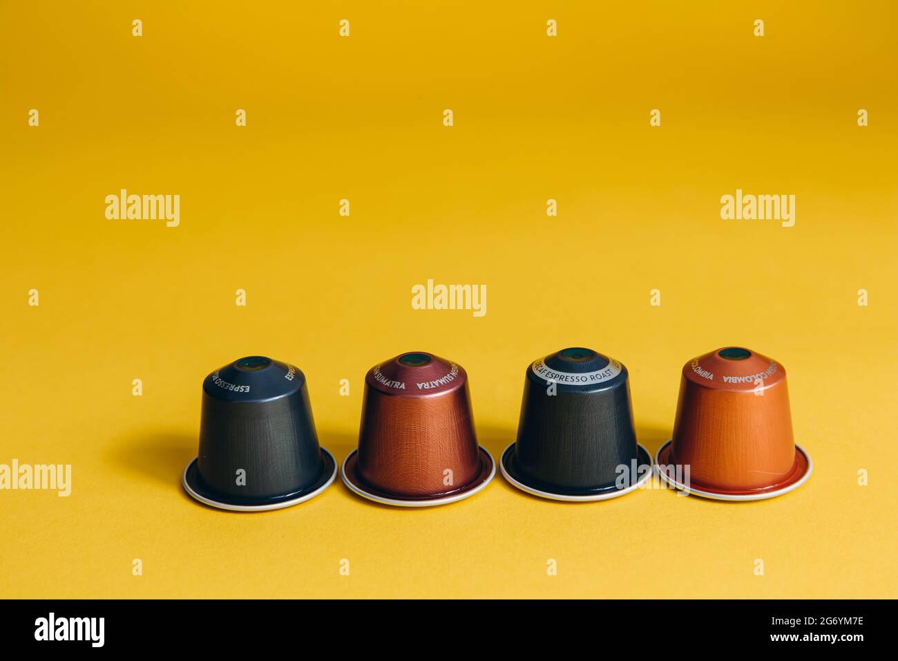 Coffee capsules for coffee machine on yellow background Stock Photo