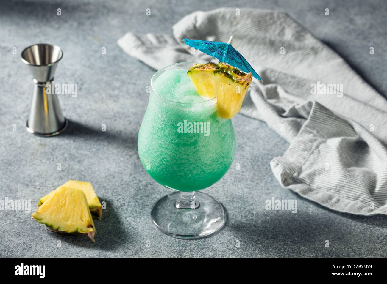 Boozy Refreshing Frozen Blue Hawaii Cocktail with Pineapple and Rum Stock Photo