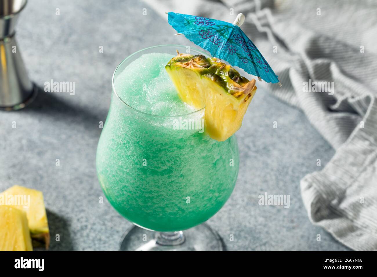 Boozy Refreshing Frozen Blue Hawaii Cocktail with Pineapple and Rum Stock Photo