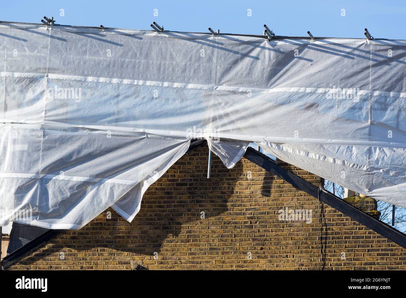 Scaffolding & covering protection on newly completed dormer / dormers / dormas / dorm on the roof on end of terrace Victorian terraced house. UK (124) Stock Photo