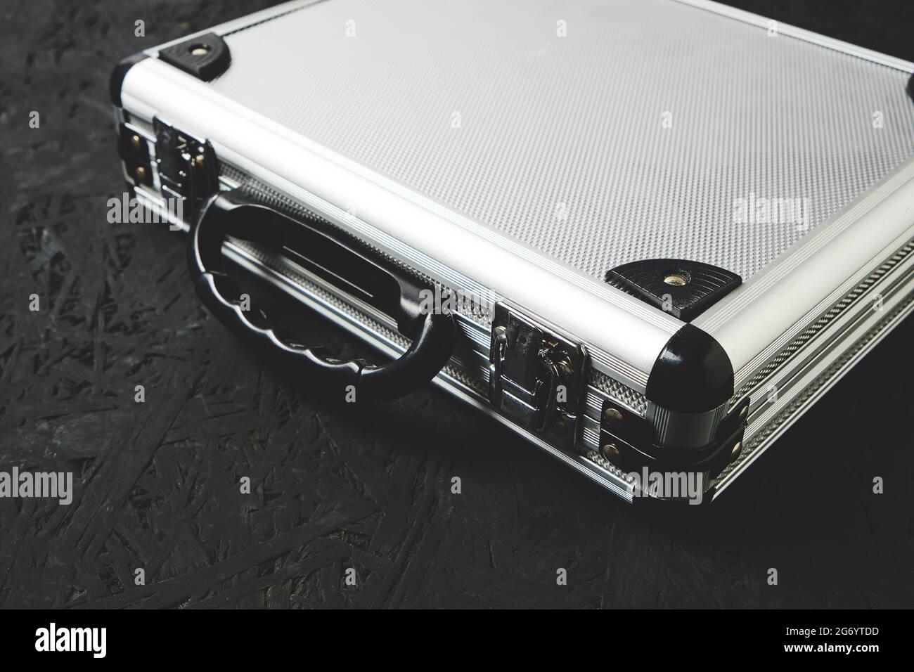 Metal aluminum briefcase on a black background Stock Photo Alamy