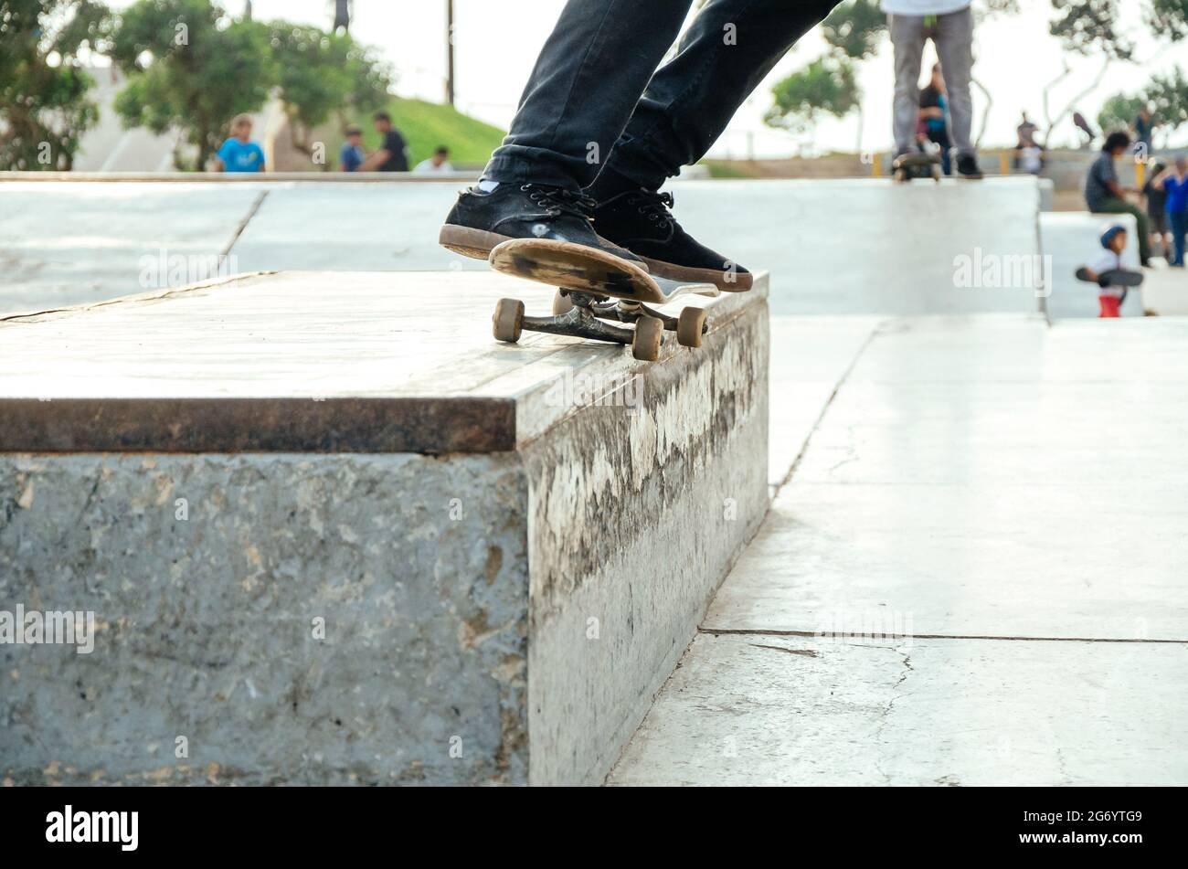 Skater doing a trick in the skatepark called grind o 50 - 50. Stock Photo