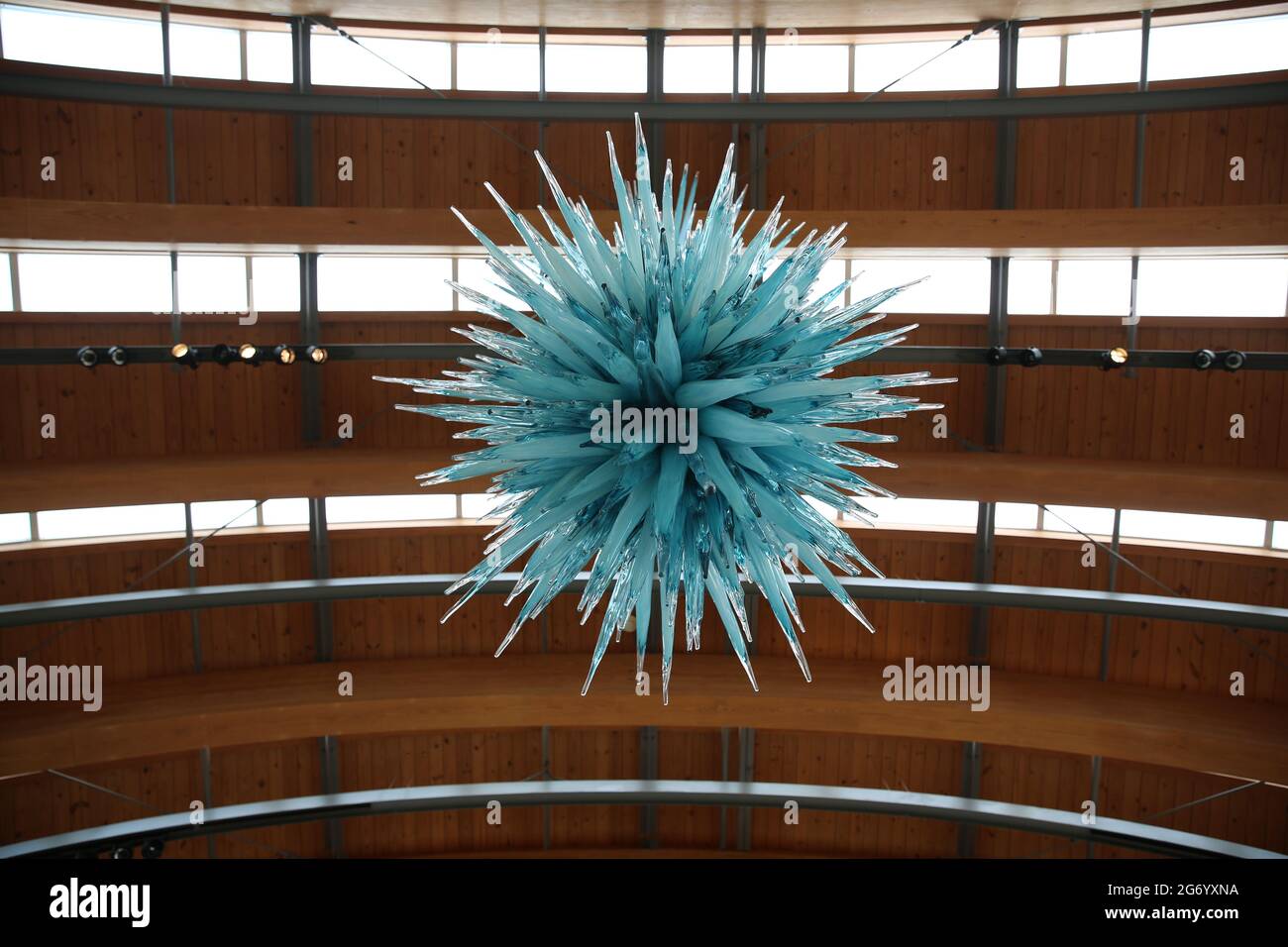 Low angle shot of a blue decorative element hanging from a wooden ...