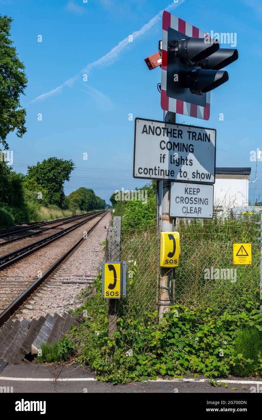 flashing lights and warning signs at a railway level crossing in west sussex southern region Stock Photo