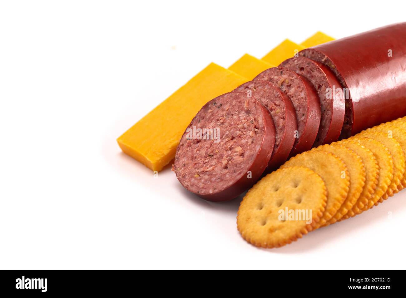 Summer Sausage Crackers and Cheddar Cheese on a White Background Stock