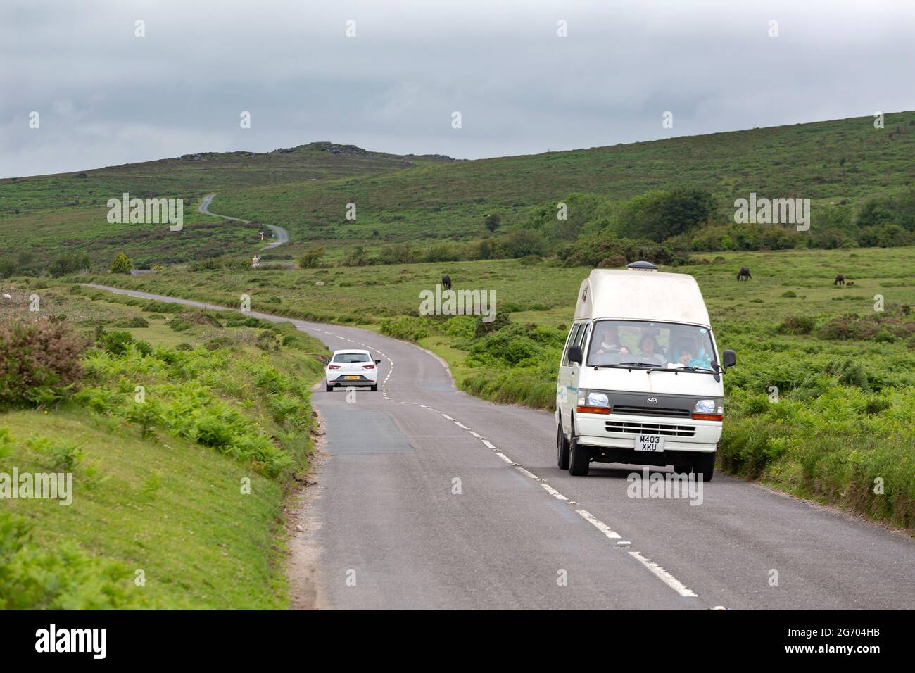 A motorhome pictured travelling along a rural road through Dartmoor National Park in Devon, UK Stock Photo