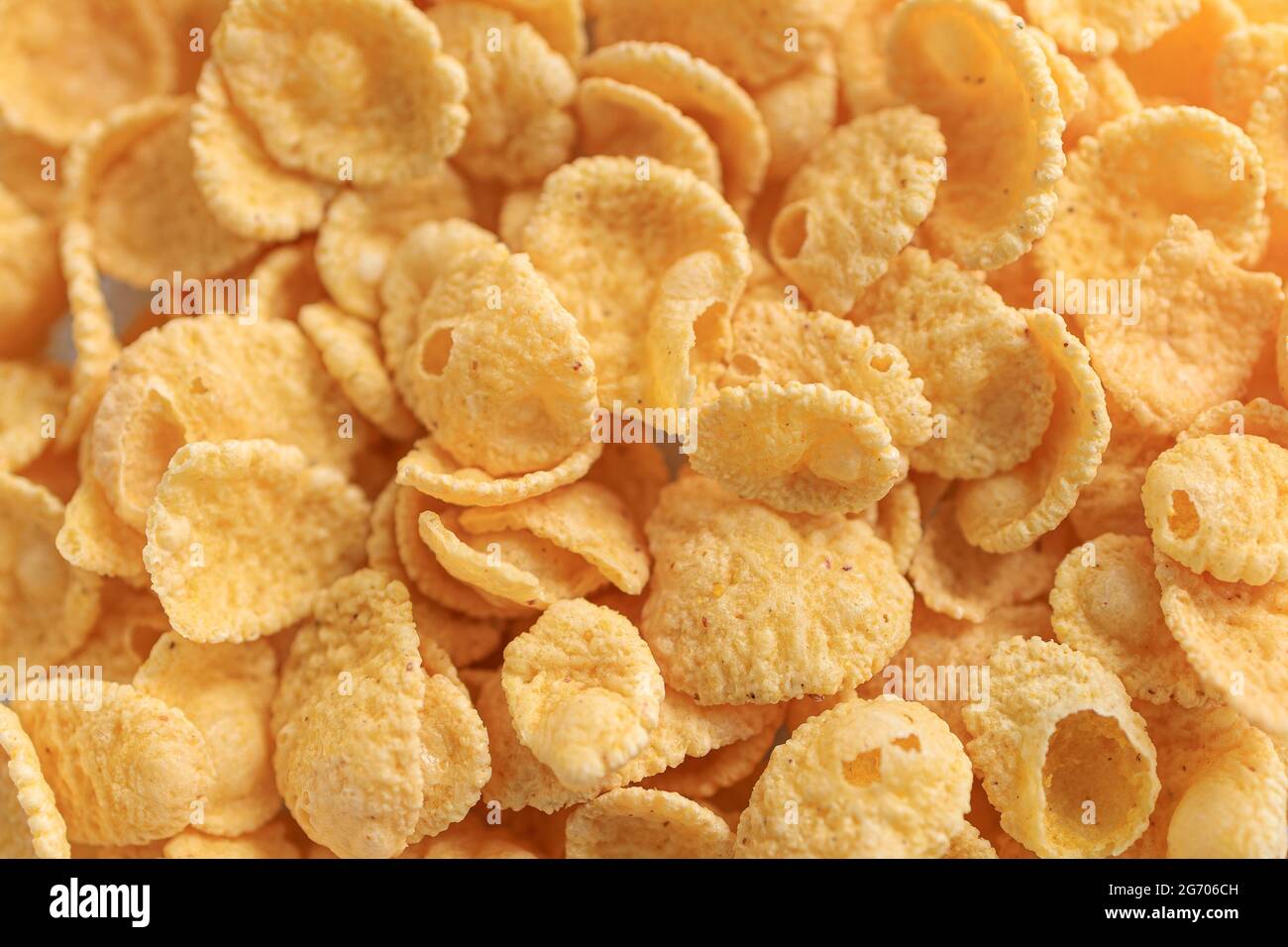 background of yellow dry cornflakes close-up. Stock Photo