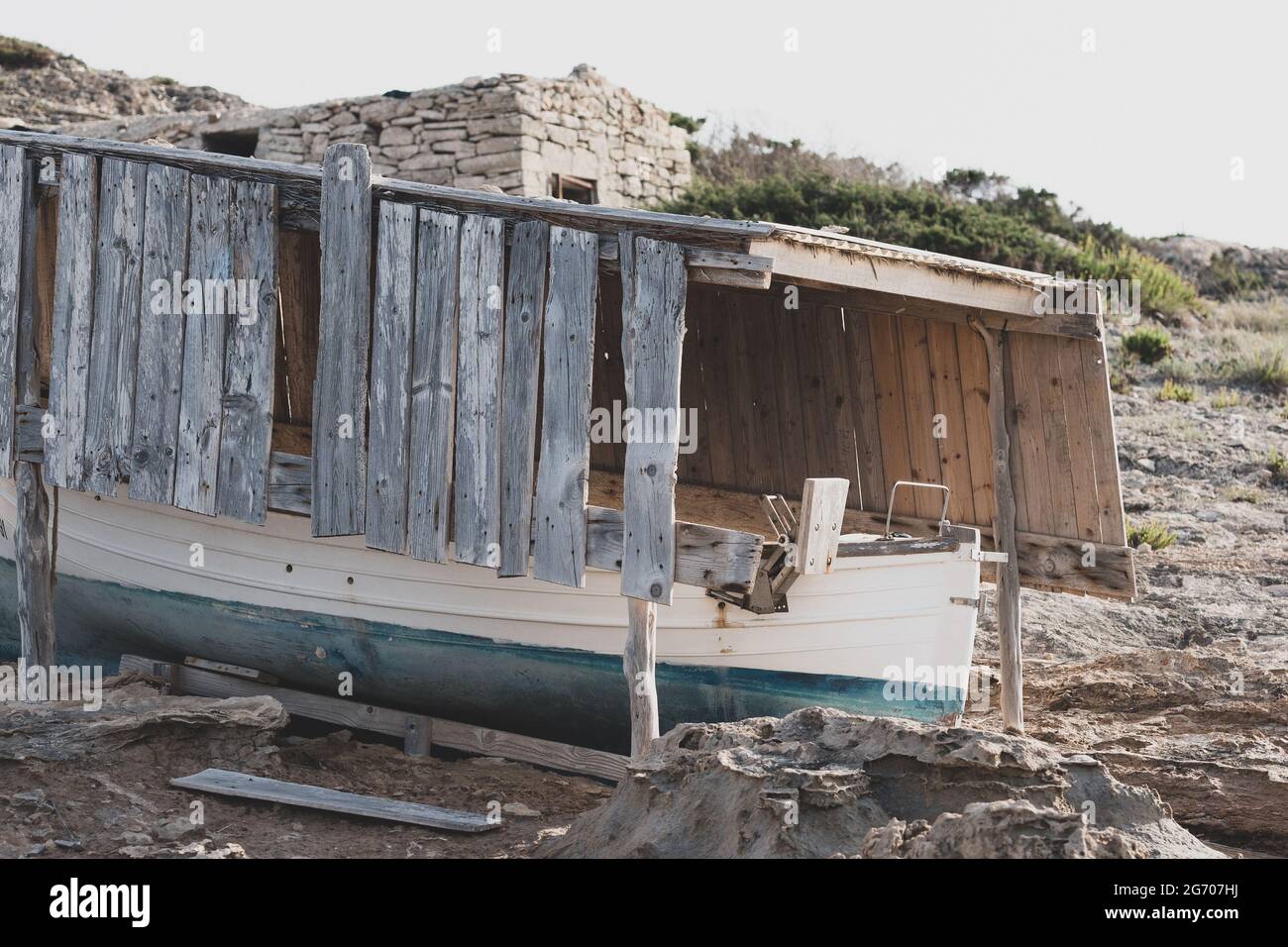 Old fishing boat and broken wooden cover on the beach Stock Photo - Alamy