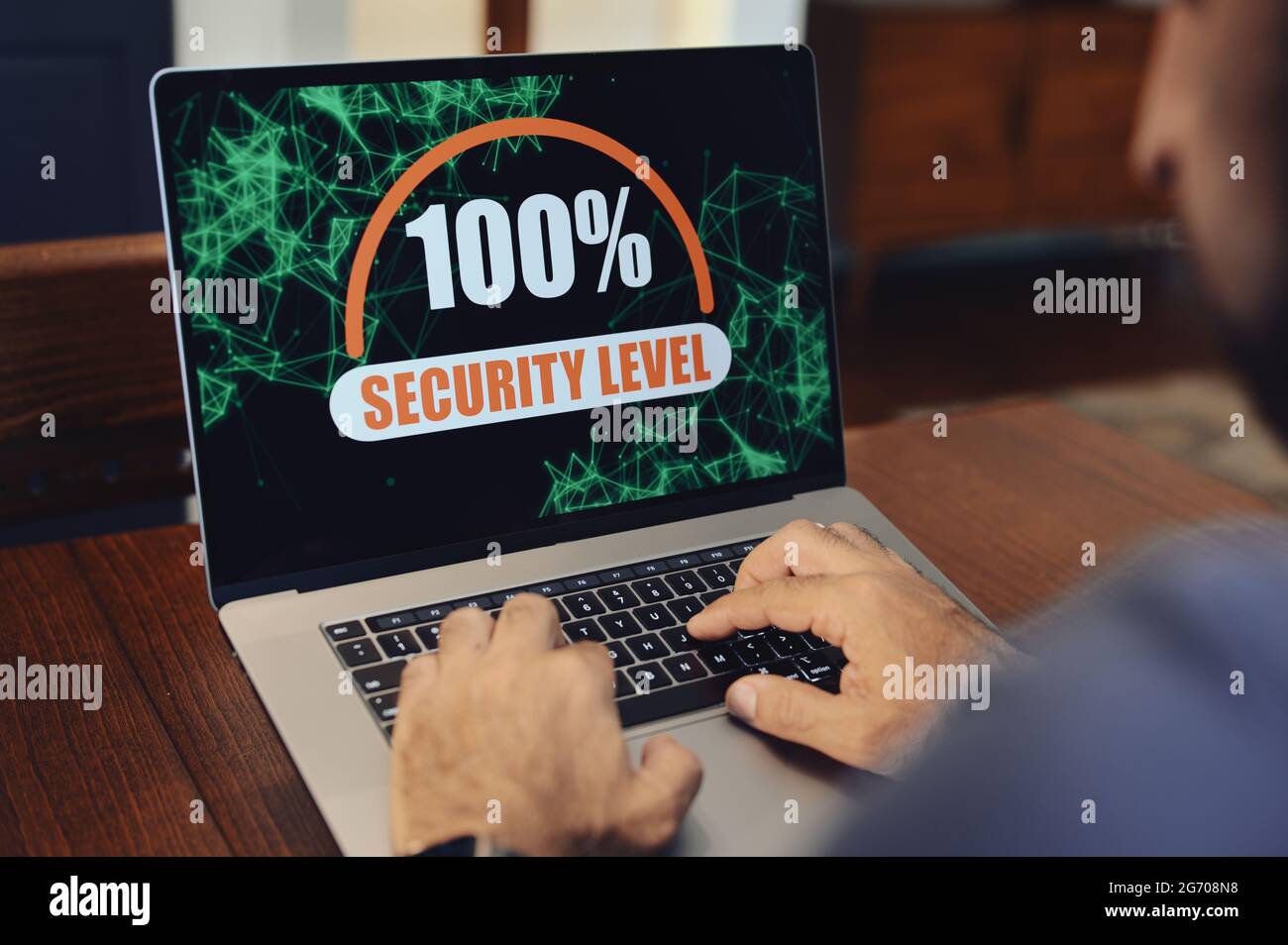 100% security level displayed on laptop computer with hands on keyboard ...