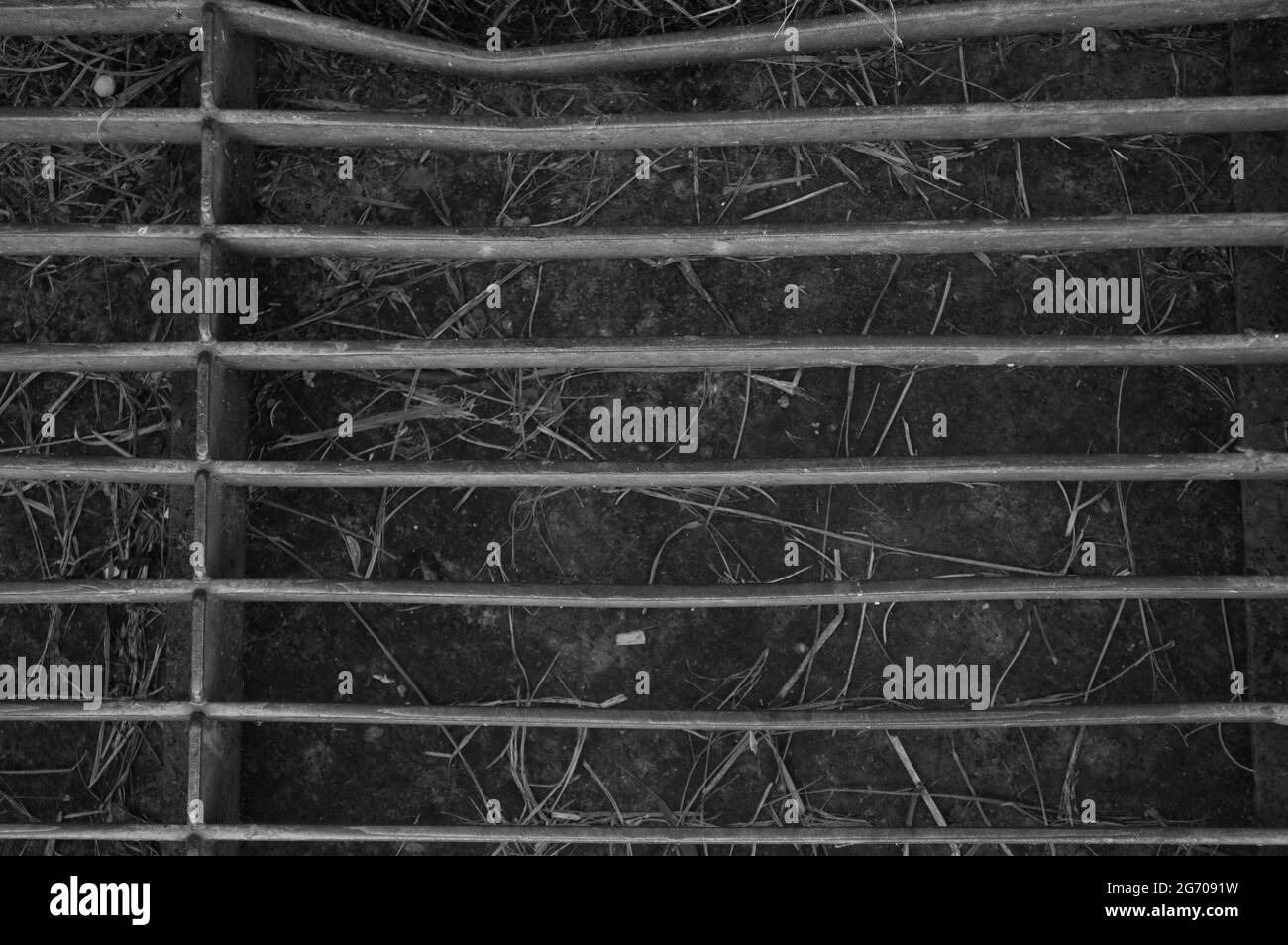 Grayscale shot of a metal "door mat" on factory to collect dirt from boots Stock Photo Alamy