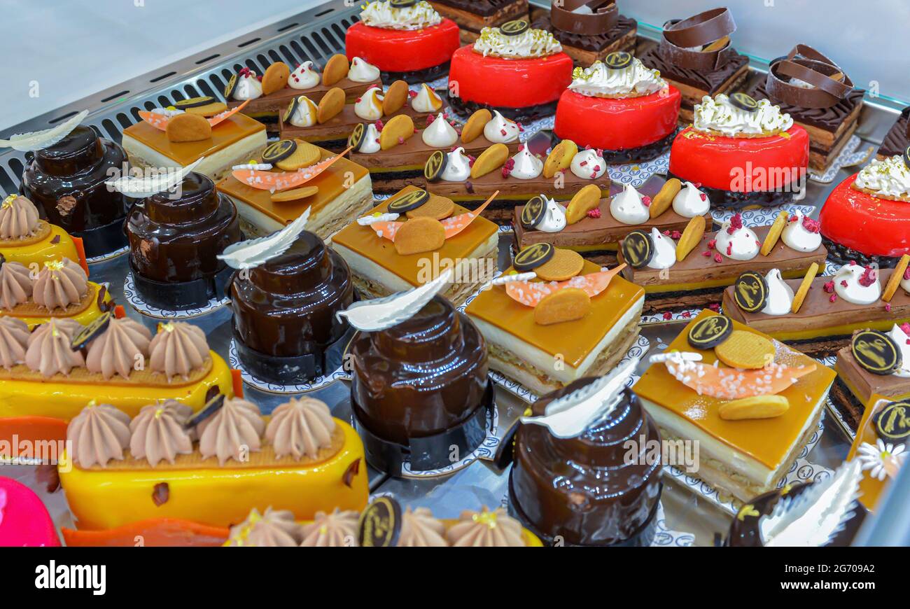 Colorful display of pastries topped with fruits in a French patisserie Stock Photo