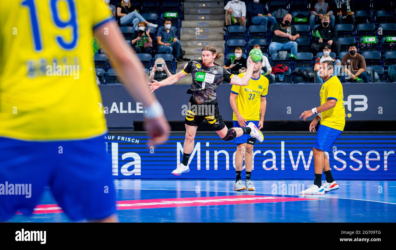 Nuremberg, Germany. 09th July, 2021. Handball: International match, Germany - Brazil. Tobias Reichmann (Germany, 3rd from right) scores from the right wing after beating Haniel Langaro. Credit: Sascha Klahn/dpa/Alamy Live News Stock Photo