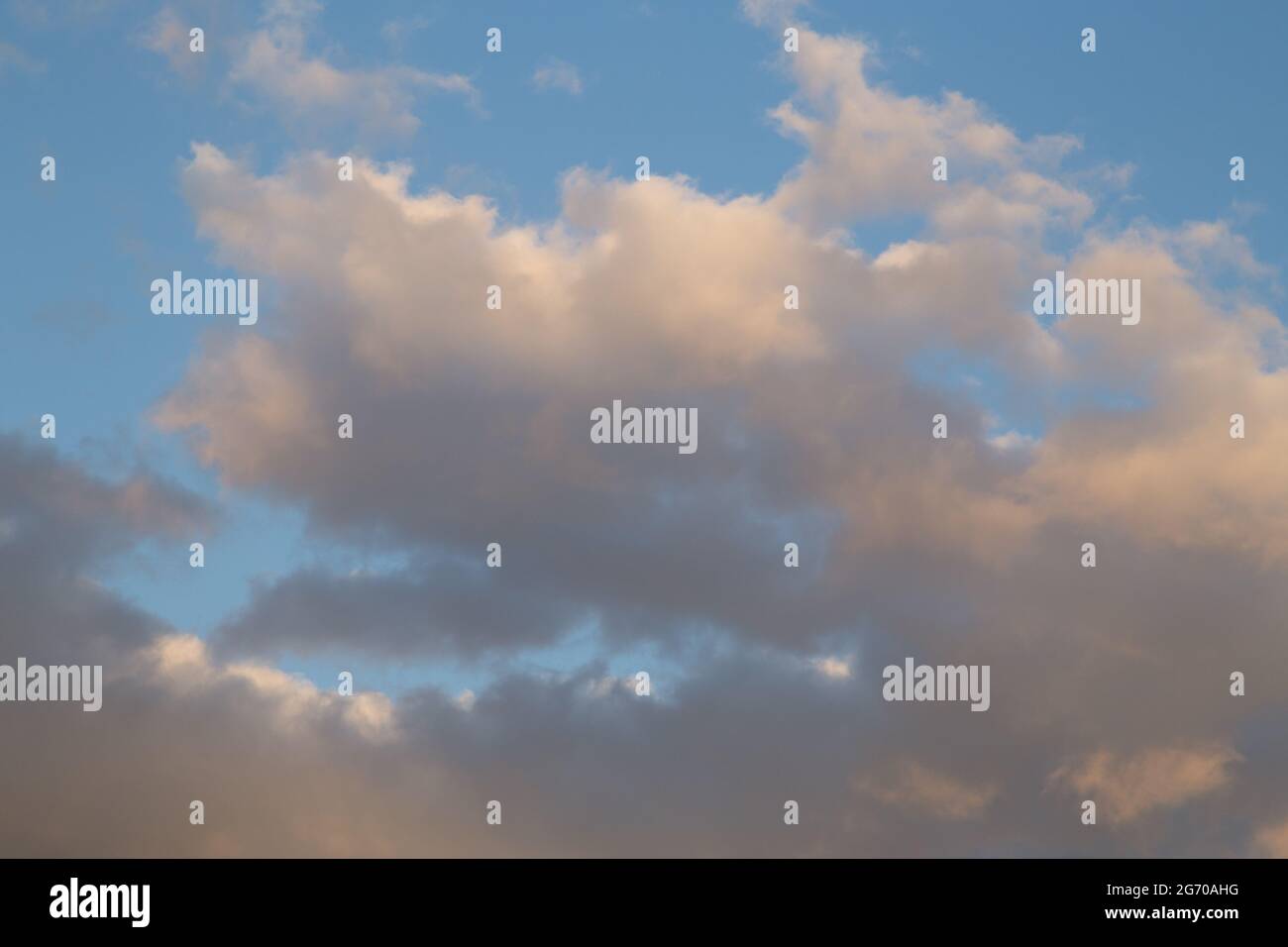 Sunset sky with yellow orange clouds - contrast between warm and cold ...