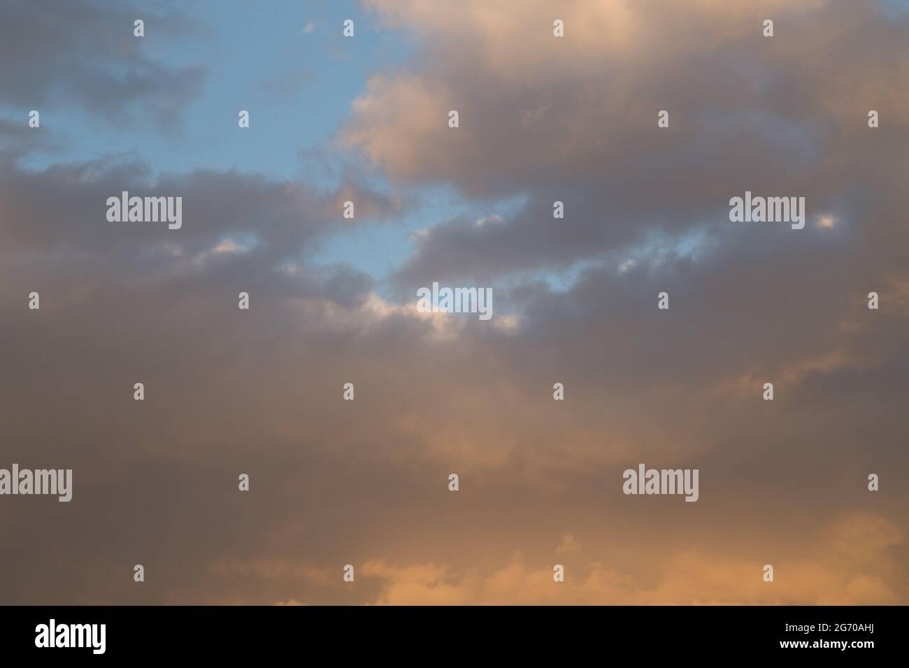 Sunset sky with yellow orange clouds - contrast between warm and cold ...