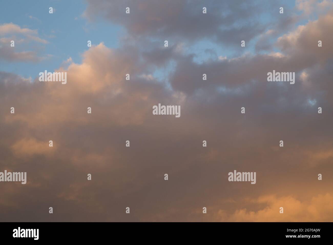 Sunset sky with yellow orange clouds - contrast between warm and cold ...