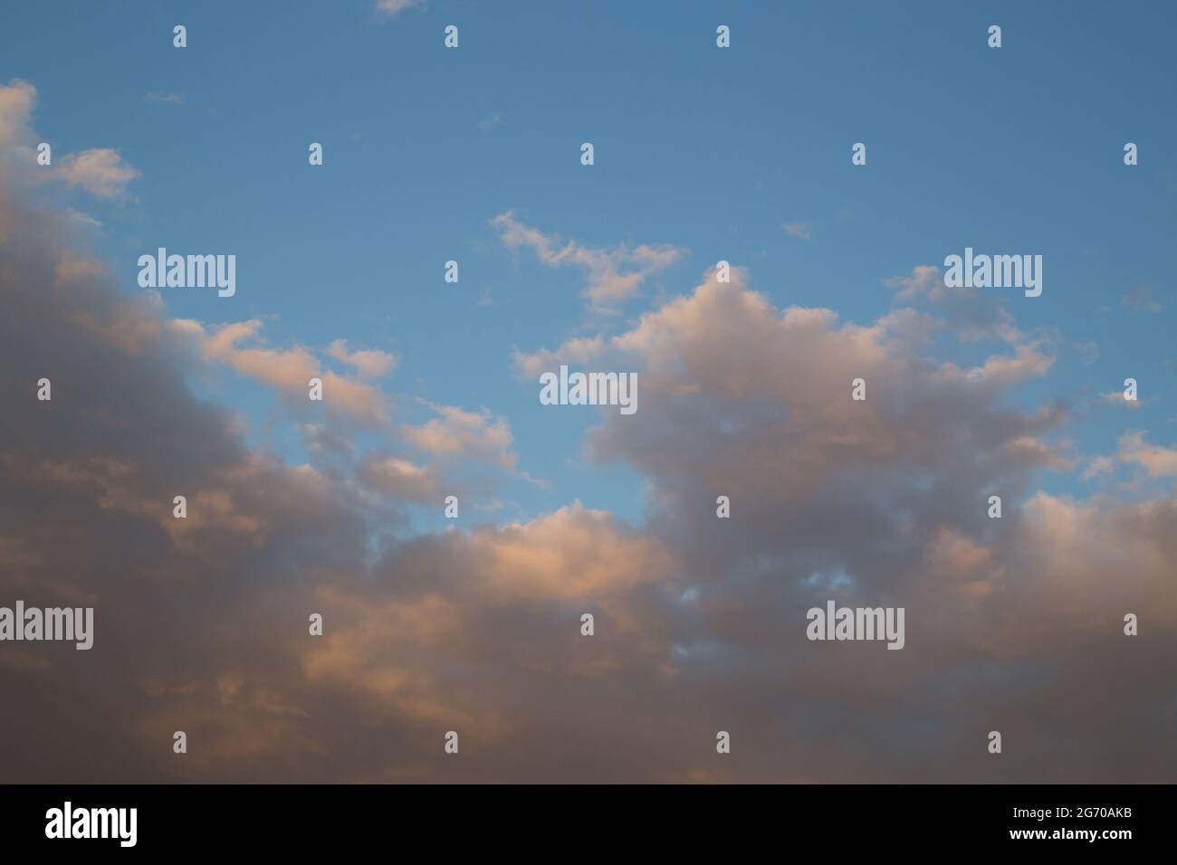 Sunset sky with yellow orange clouds - contrast between warm and cold ...