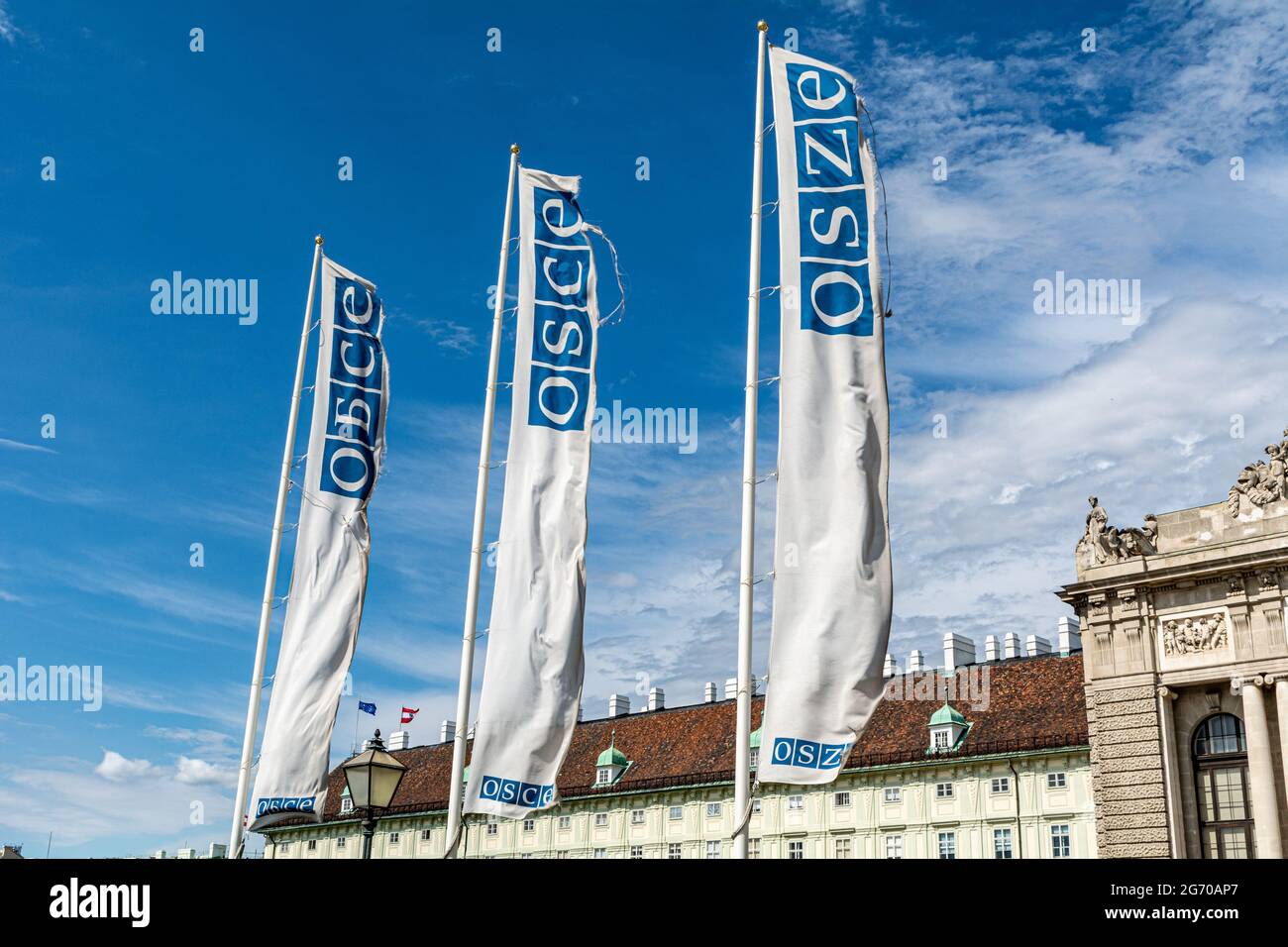 Flags of the OSCE (Organization for Security and Co-operation in Europe) against a blue sky in Vienna, Austria Stock Photo