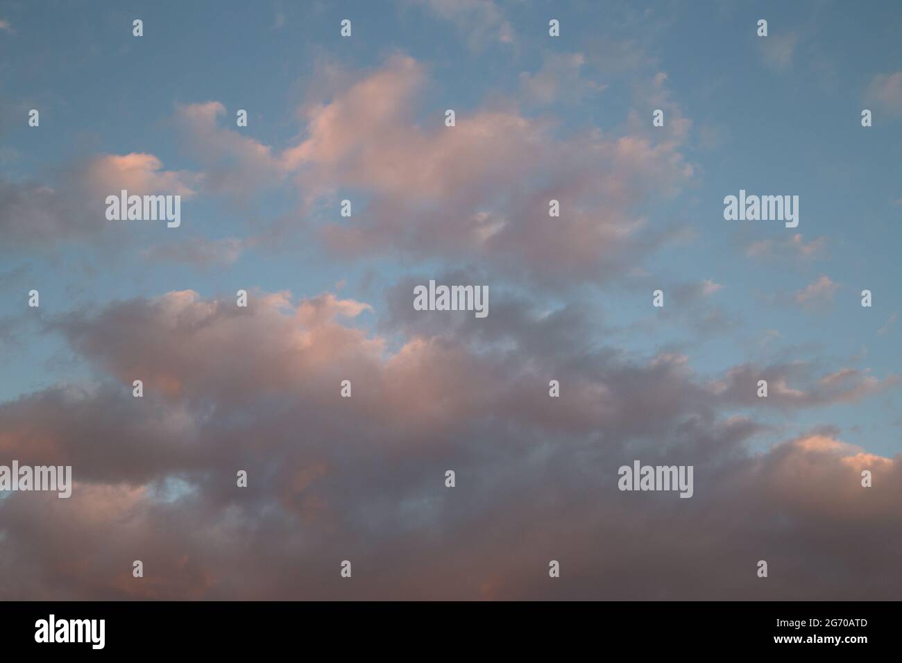 Sunset sky with yellow orange clouds - contrast between warm and cold ...