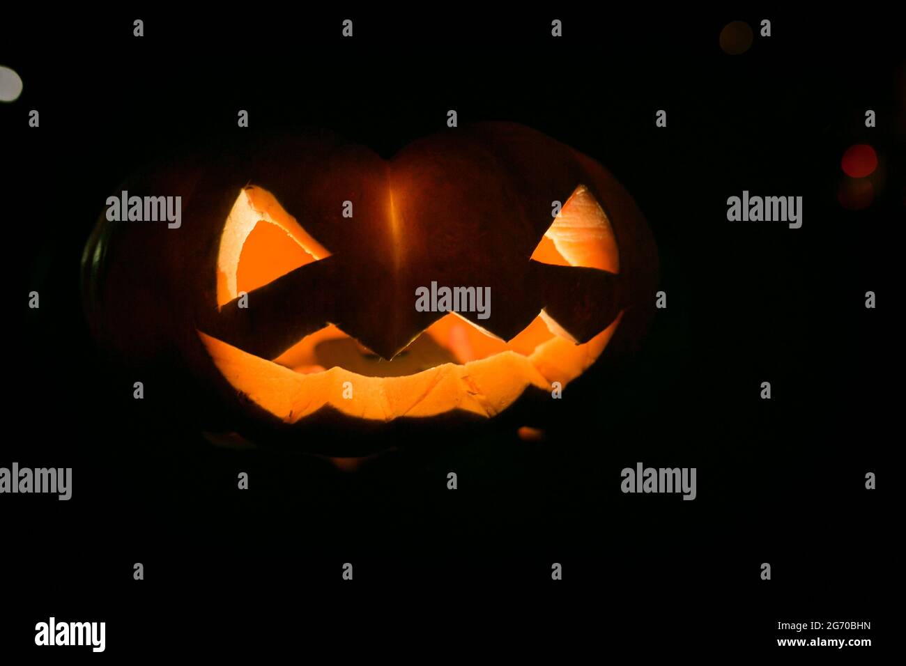 Burning halloween pumpkin head at night on dark background. Halloween dark festive background. Stock Photo