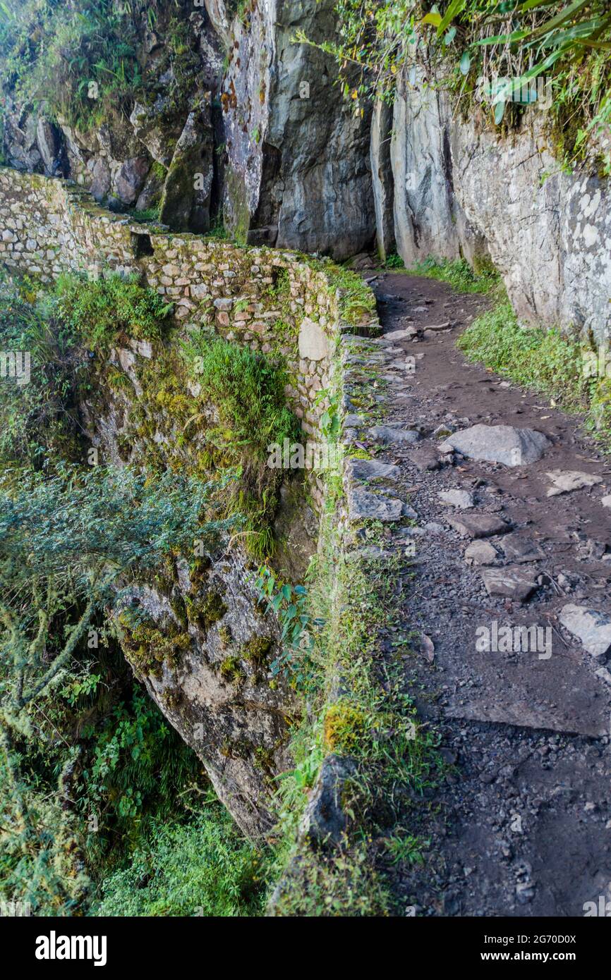Inca trail carved into a stone wall near Machu Picchu ruins, Peru Stock ...