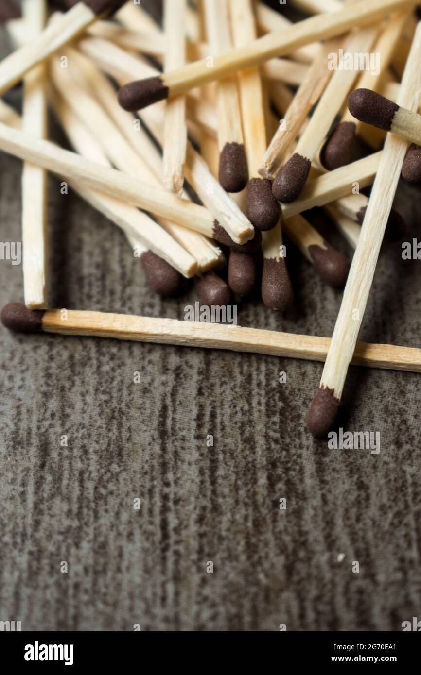 Some wooden matches on a clorful on a grey wooden surface Stock Photo